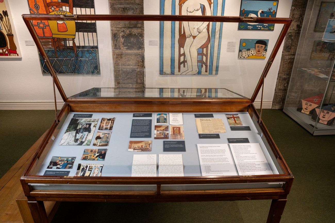 A display case of photographs and documents