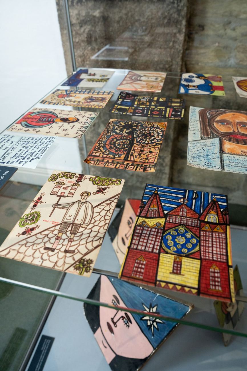 Painted cards and small works in a display case